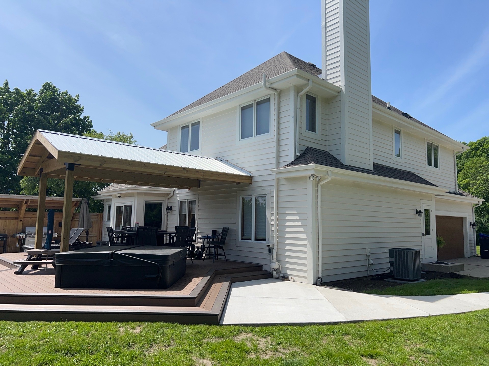 Small Covered Pergola next to a back-porch with an overhang and a Hot Tub