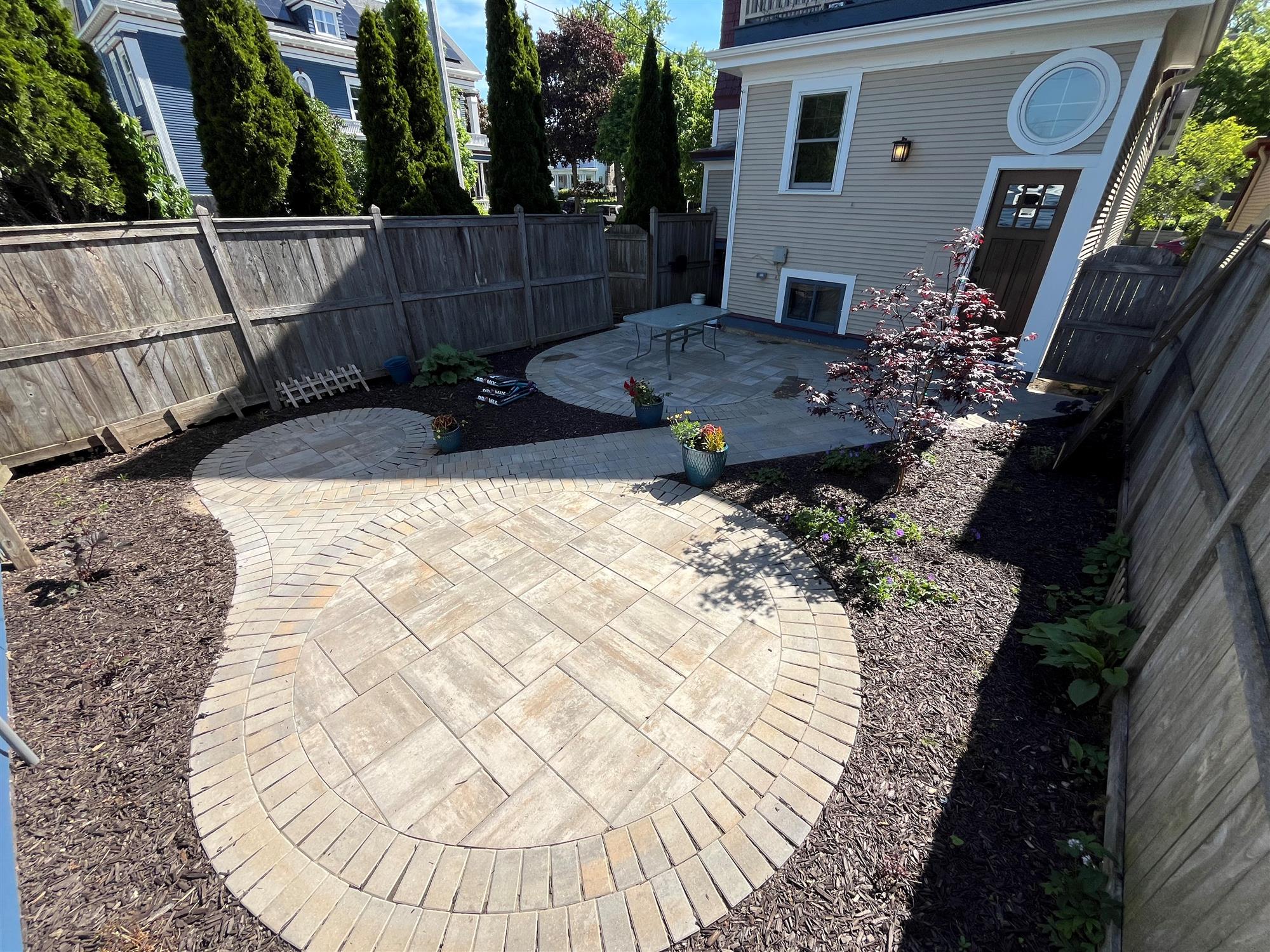 Fenced Backyard Retreat with Three Circular Patio Sections