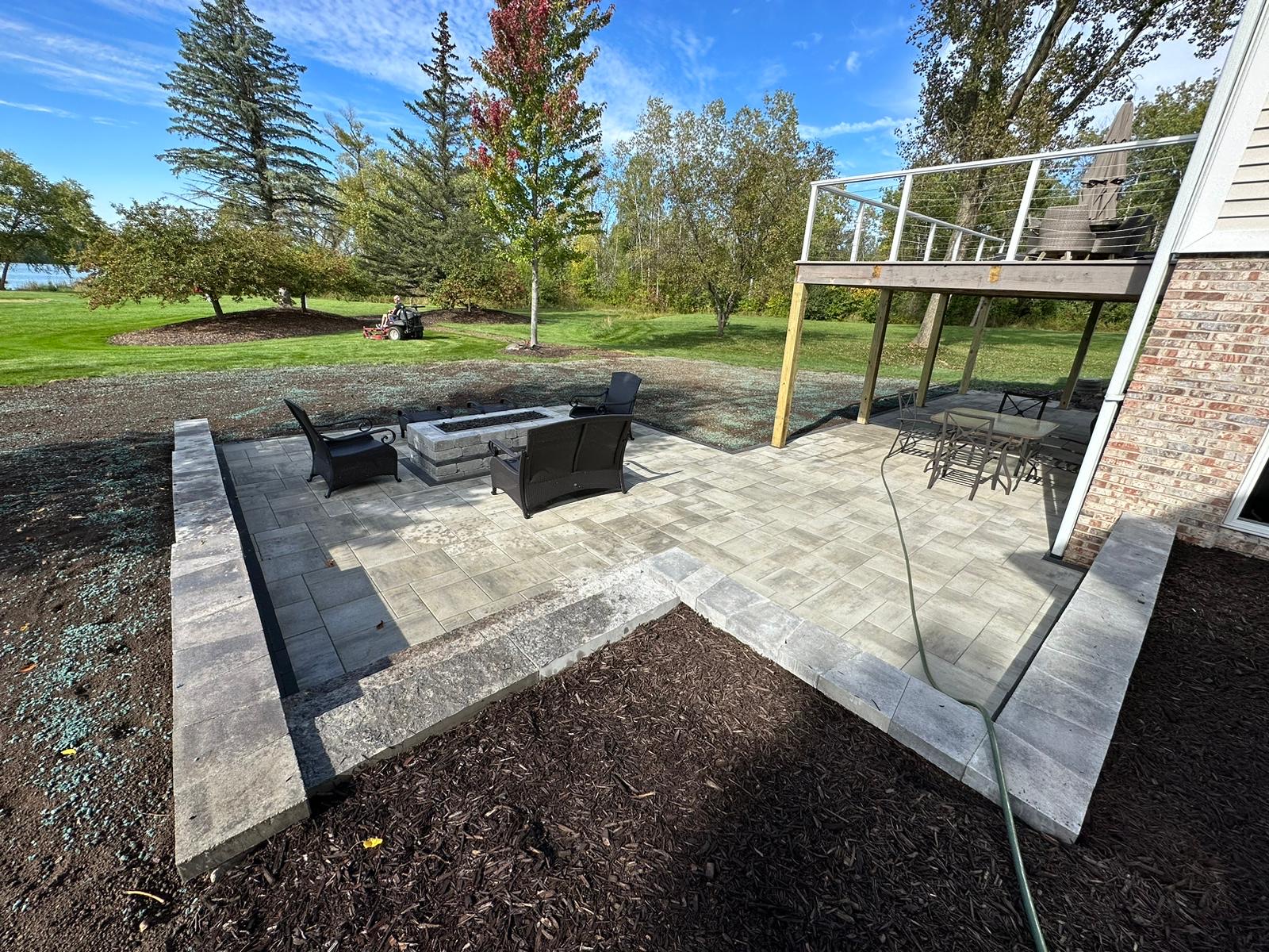 Backyard Patio with Small Retaining Walls and a Fire Pit