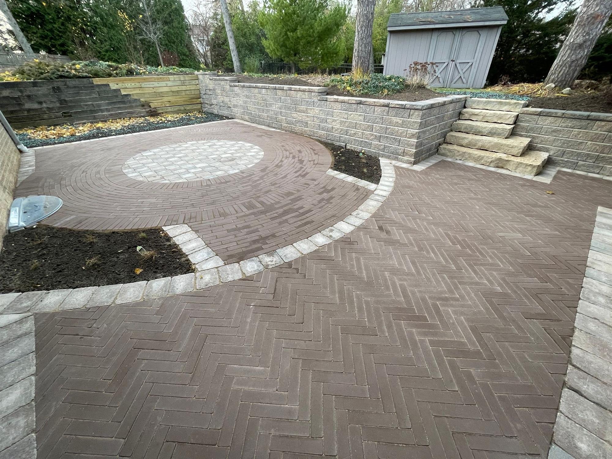 Patio with Tall Retaining Walls and Large Stone Slab Stairs up to a Shed