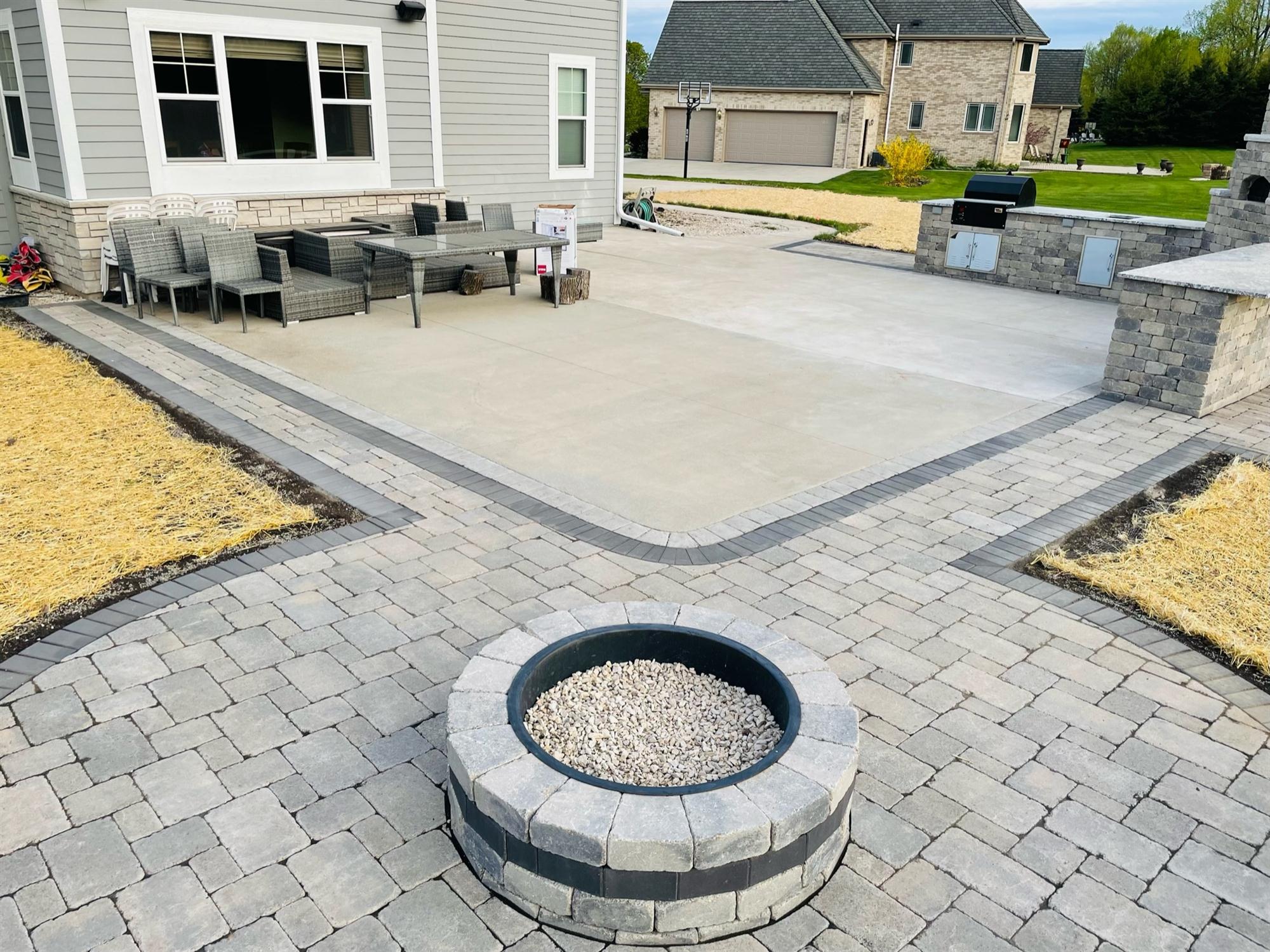 Backyard brick fire pit with sitting wall patio addition