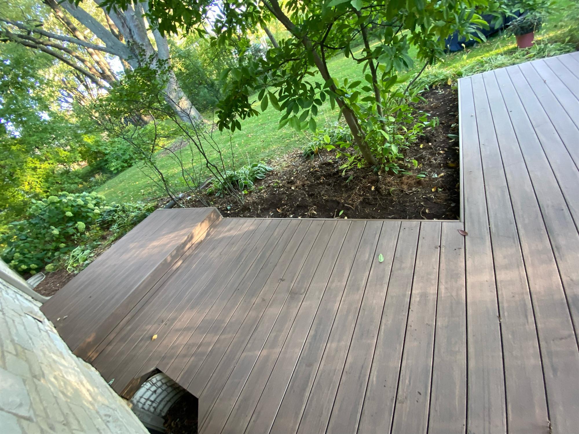 Backyard wooden deck with no railing