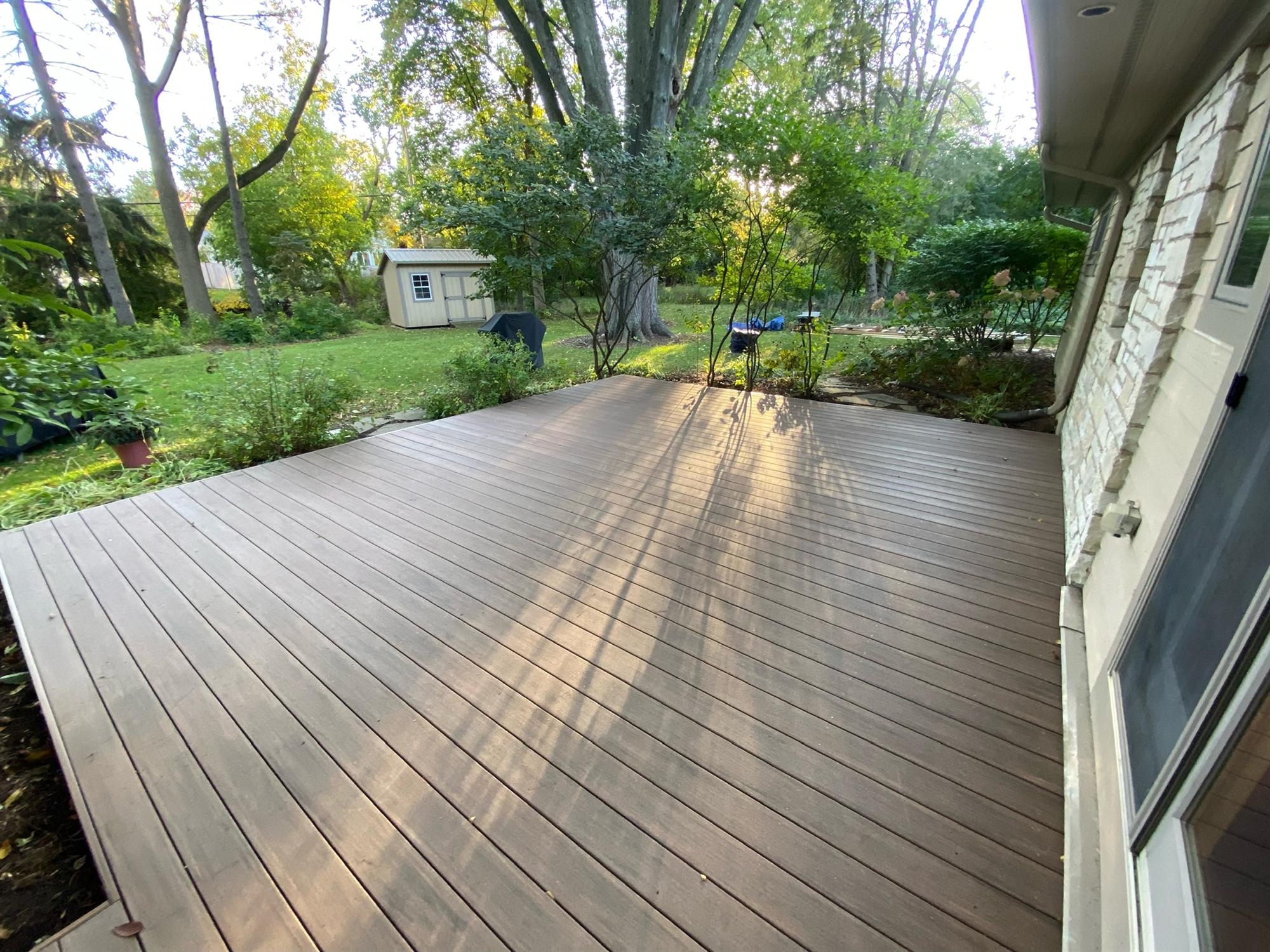 Square wood deck in back yard 