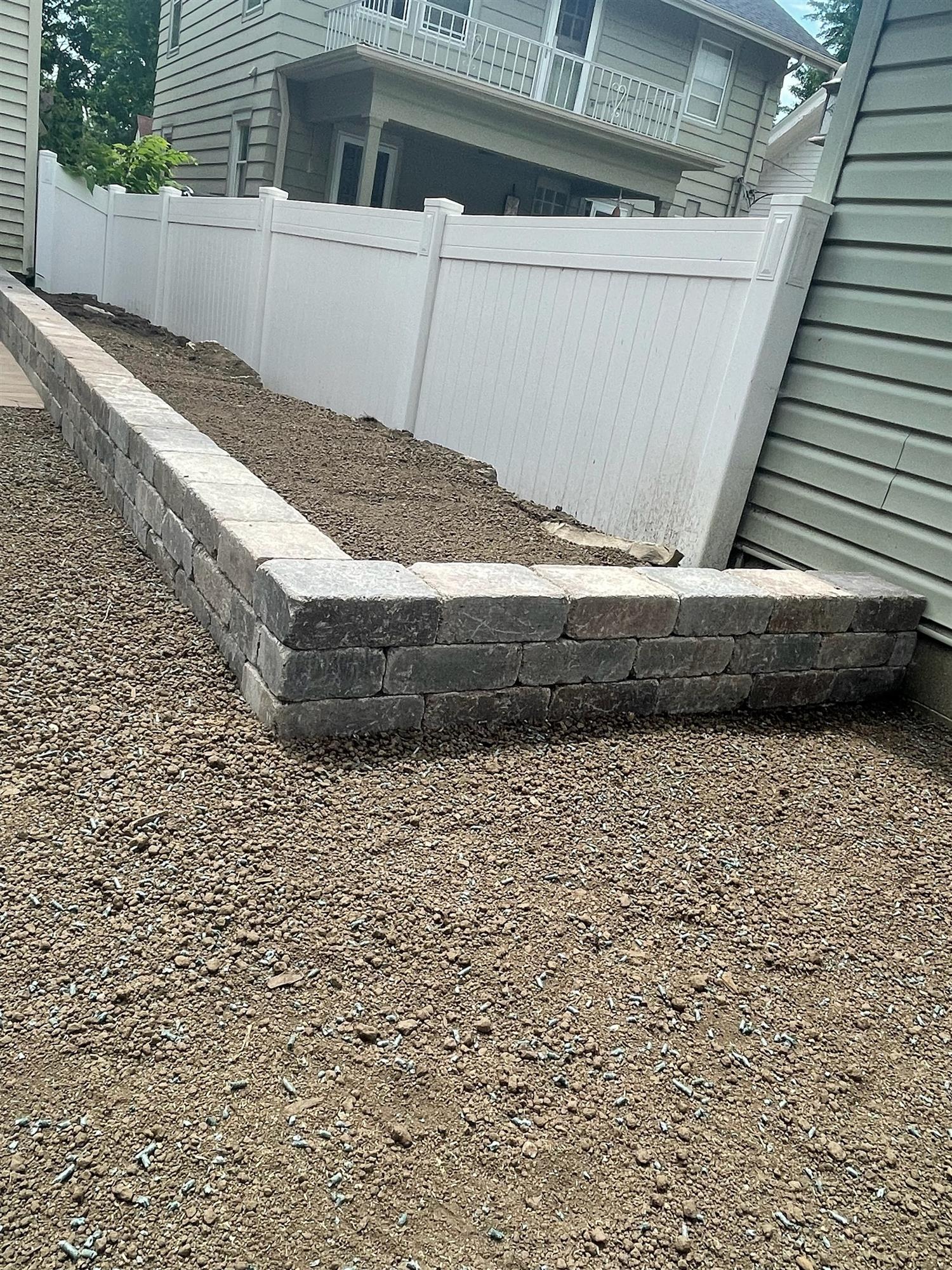 Backyard brick retaining wall installation 