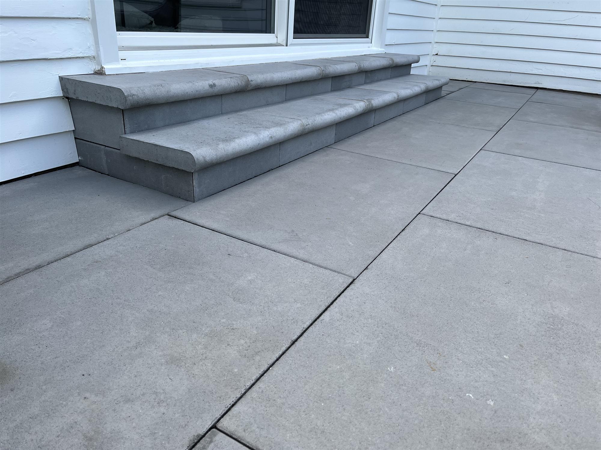 Backyard patio with large slabs & stairs