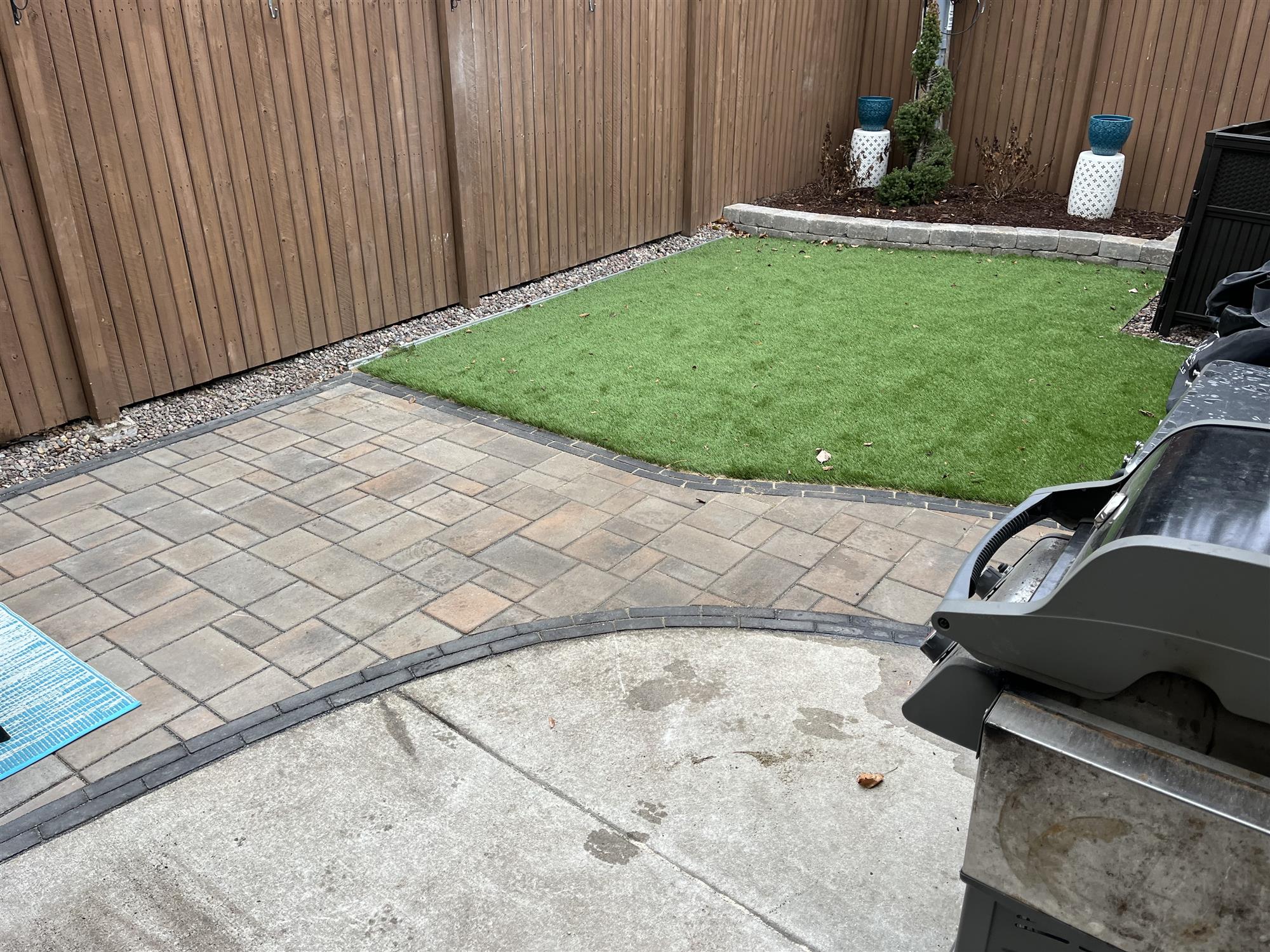 Brick patio addition with turf lawn