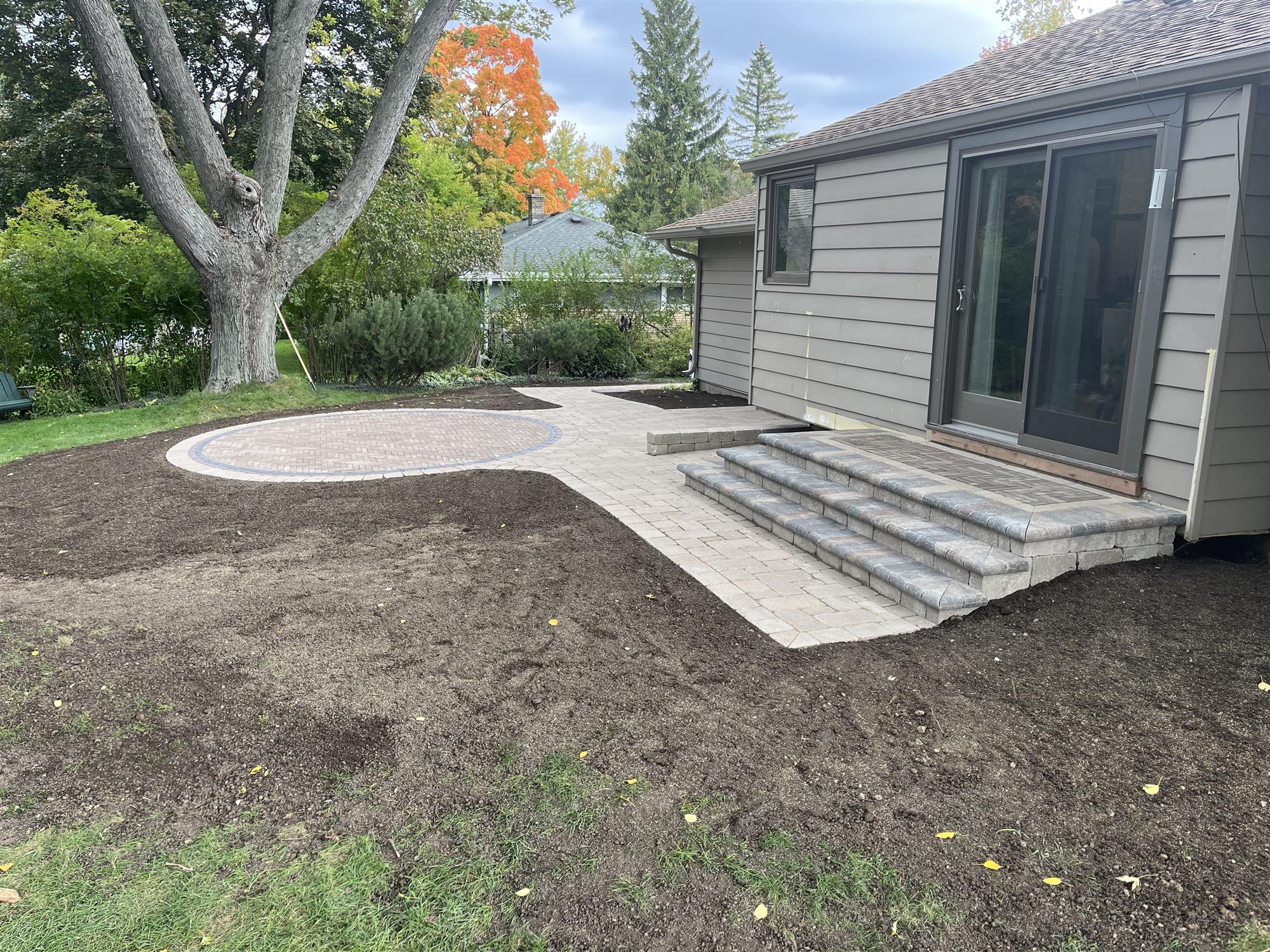 Circular backyard patio with steps