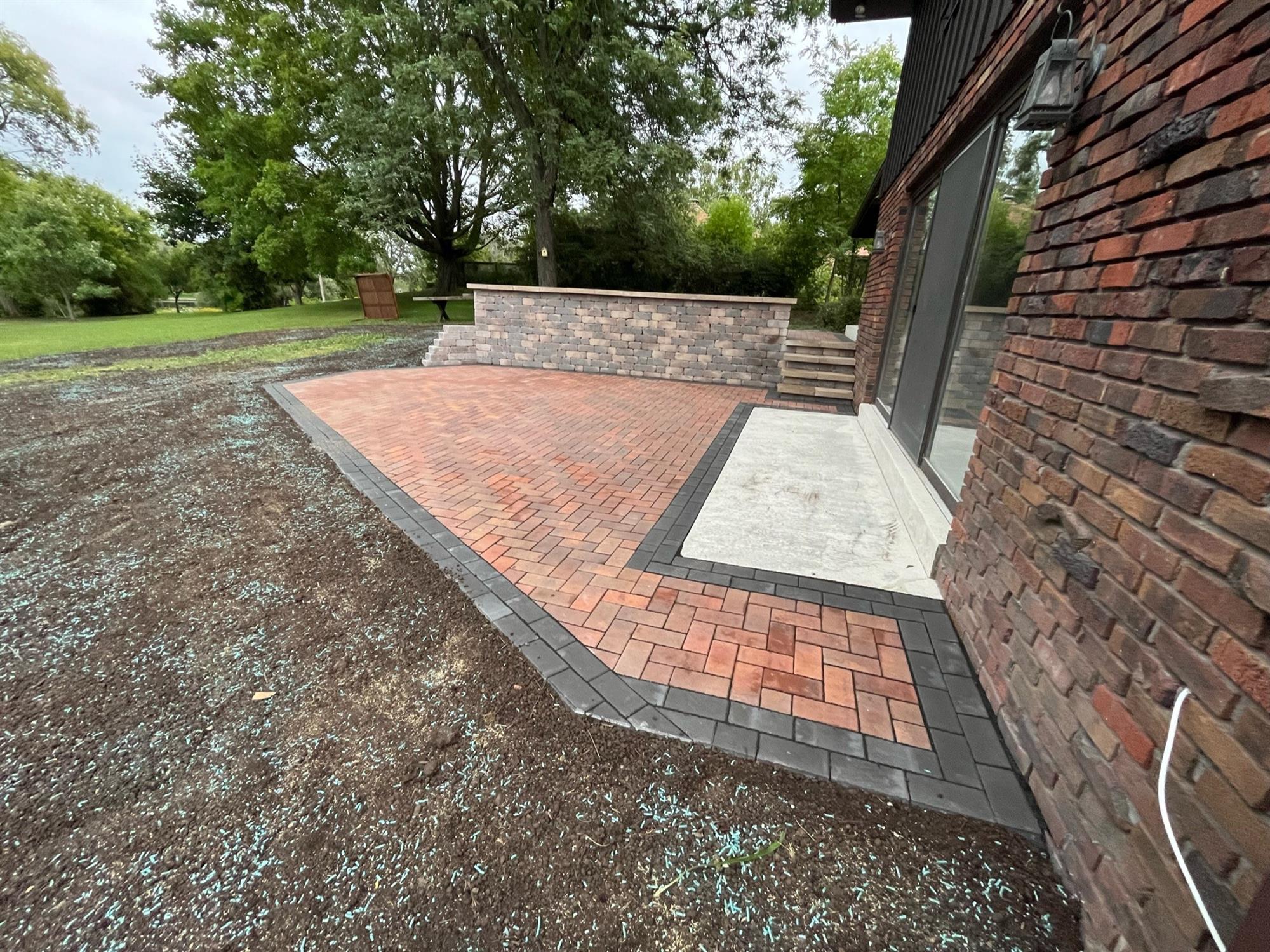 Red and Dark Gray Brick Multi-Level Patio with Attached Retaining Wall