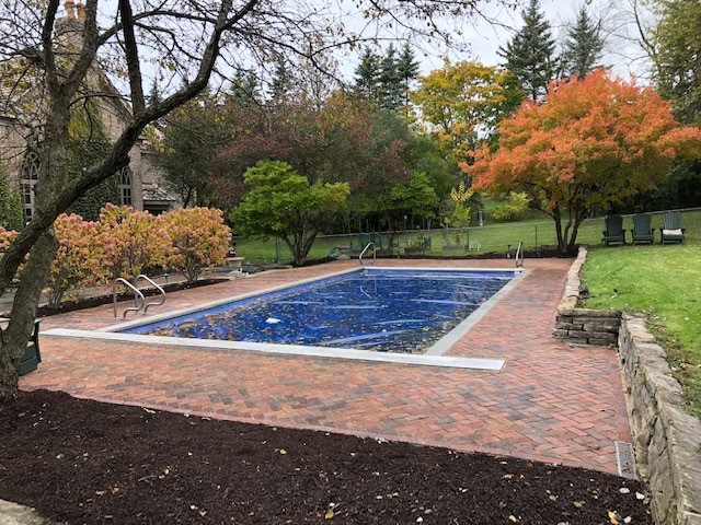 red brick paver patio around swimming pool 