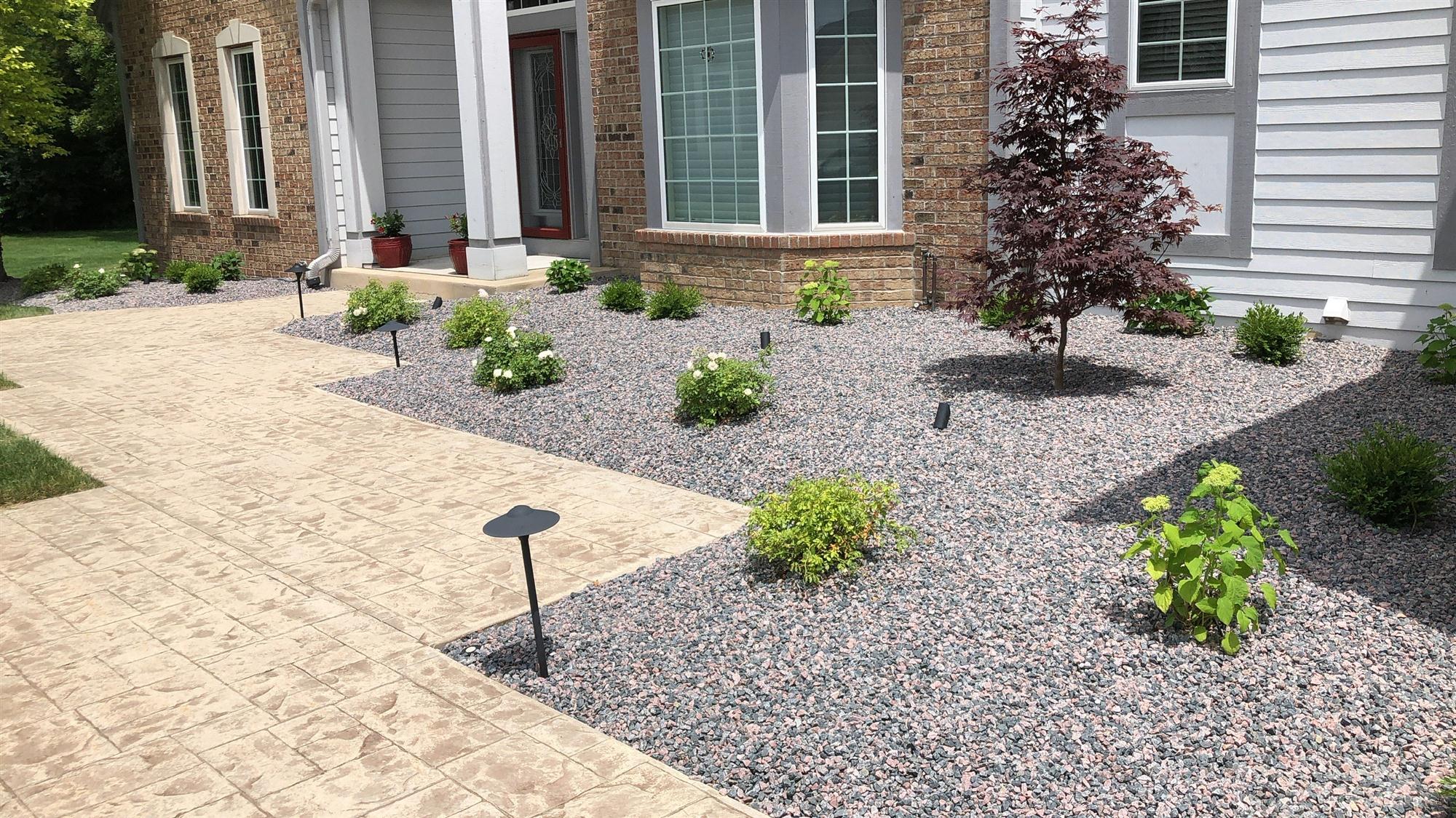 Paver stone walkway with gravel landscaping