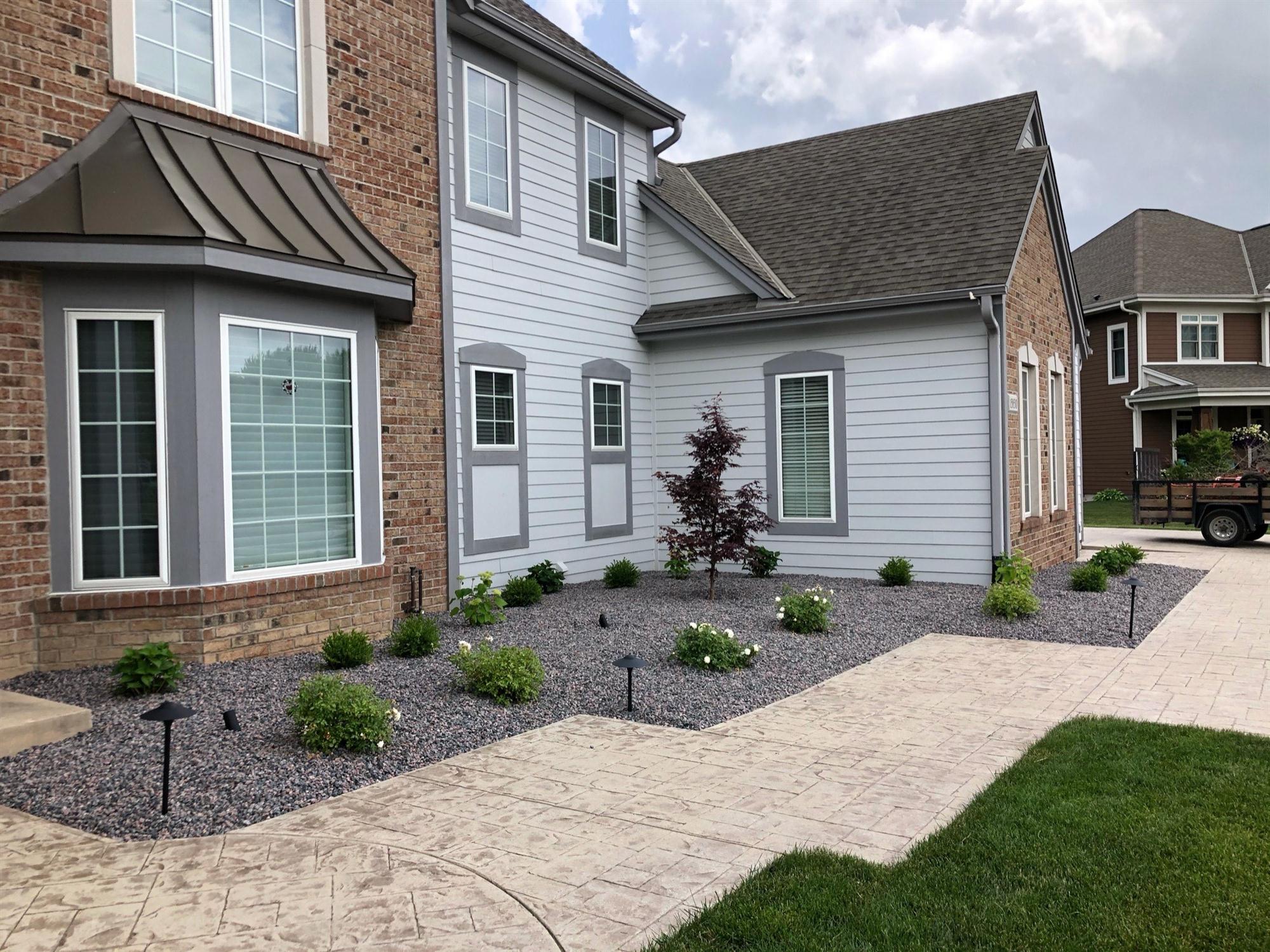 Pea gravel outdoor landscaping with plants in Wisconsin
