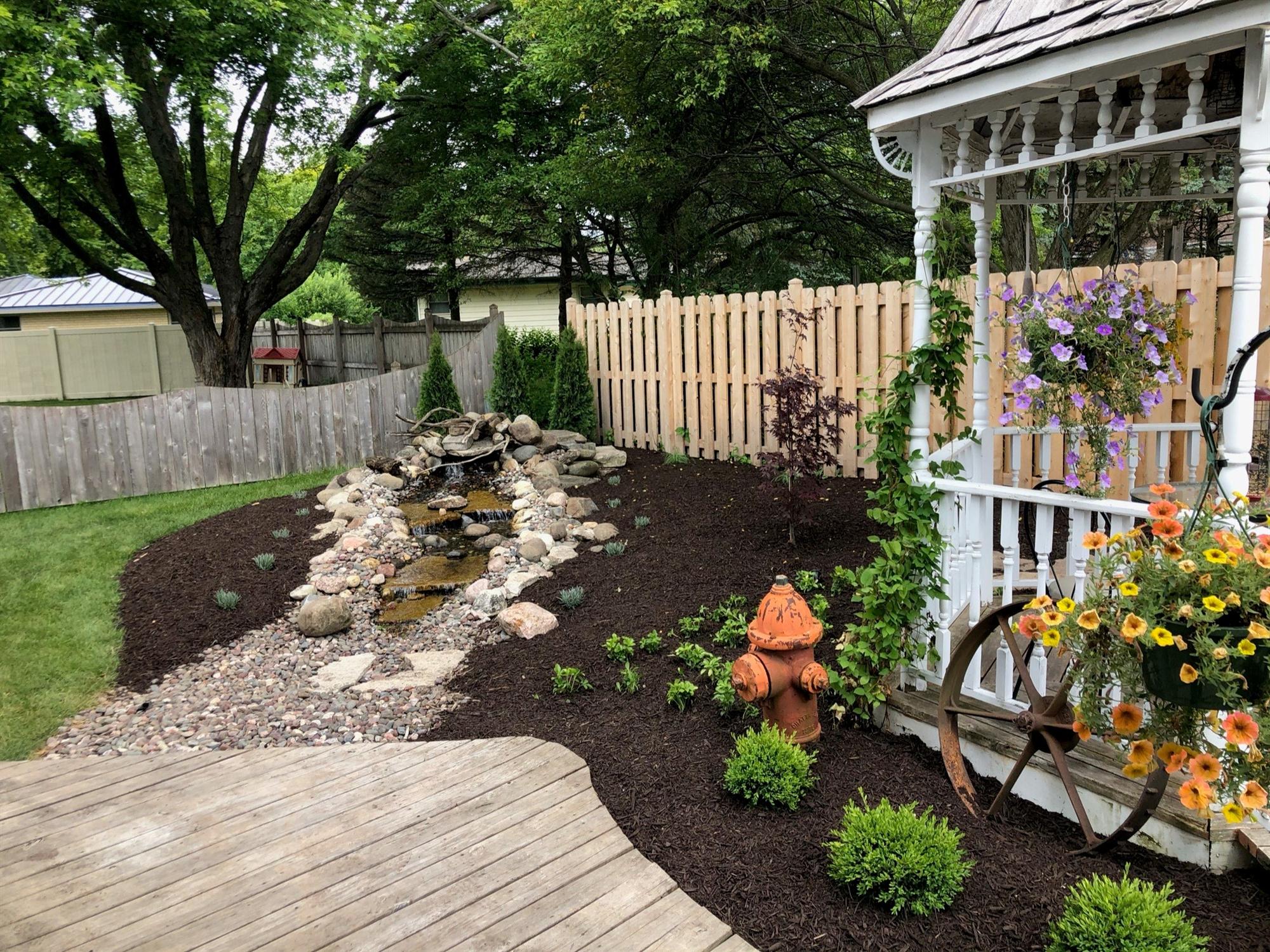 Water Feature Landscaping in backyard Water feature and flower bed in Wisconsin