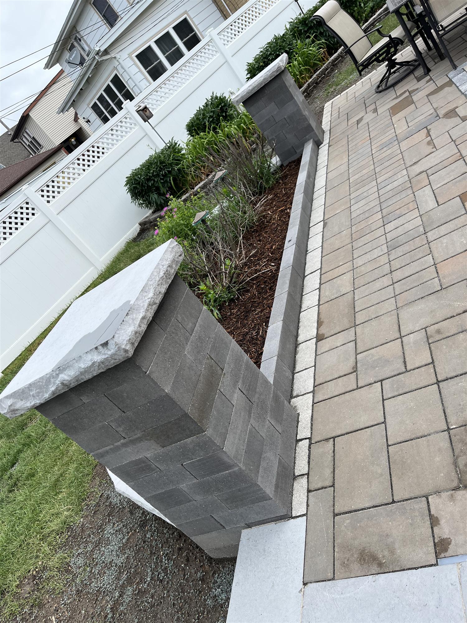 Brick patio with sitting wall and pillars