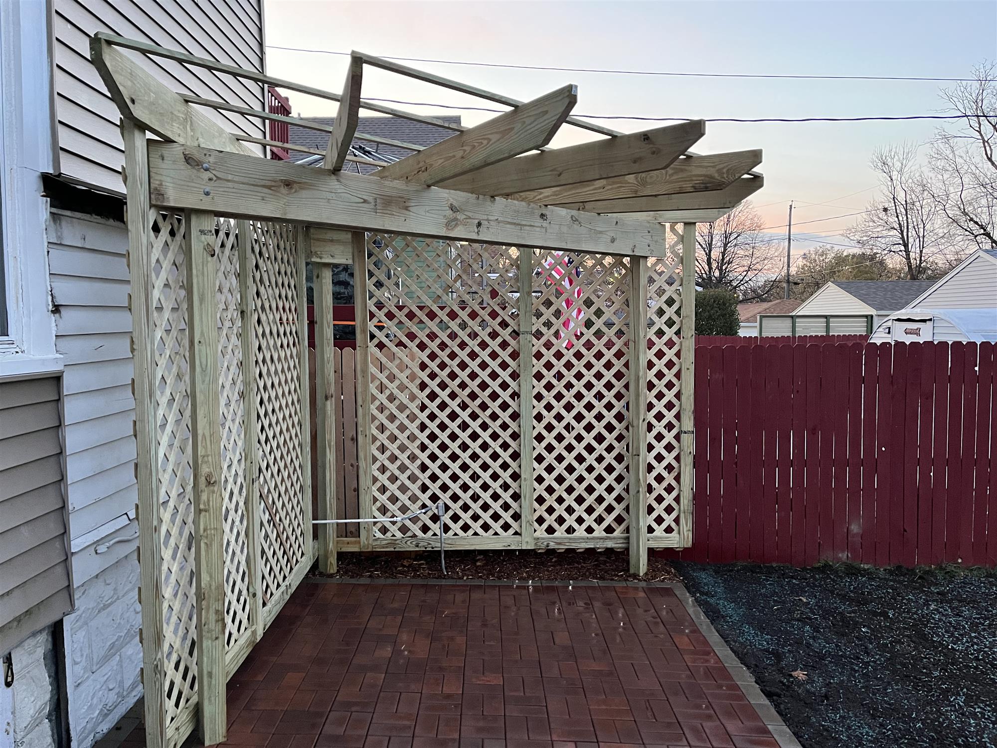 Red brick patio addition with small pergola