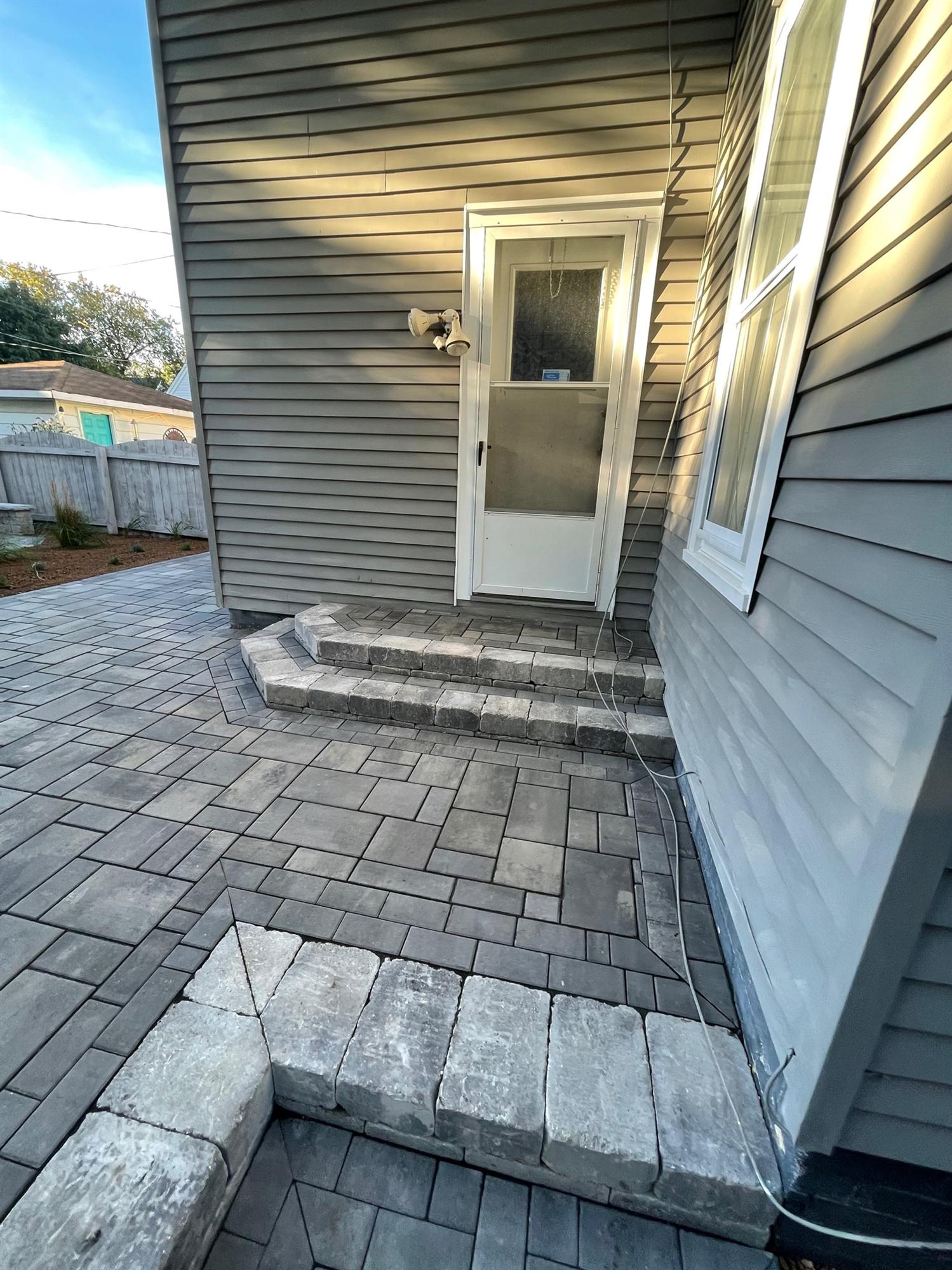 Stone backyard patio with steps
