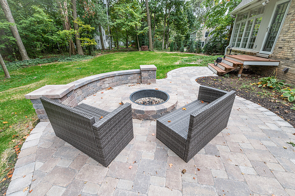 Stone patio with sitting wall and outdoor fire pit