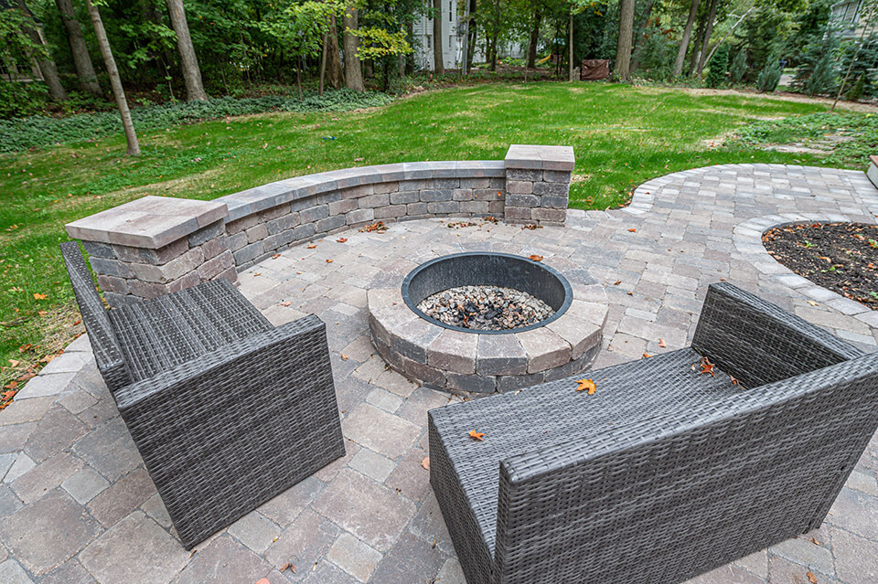 Stone paver patio with stone sitting wall and stone outdoor fire pit