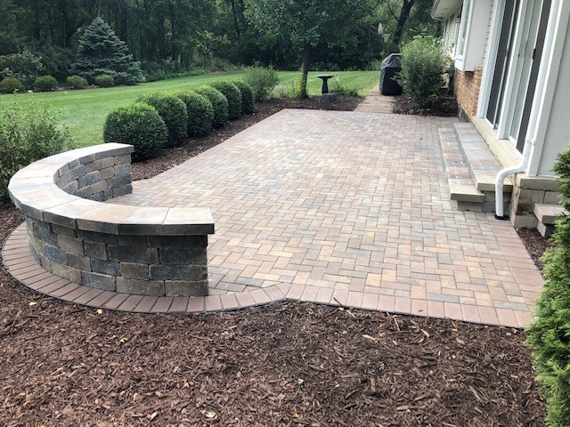 Stone paver patio with stone sitting wall