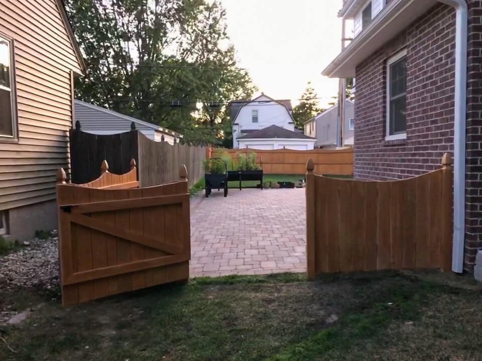 Red brick paver patio with new fence