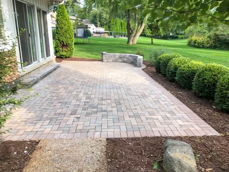Stone paver patio with small stone sitting wall