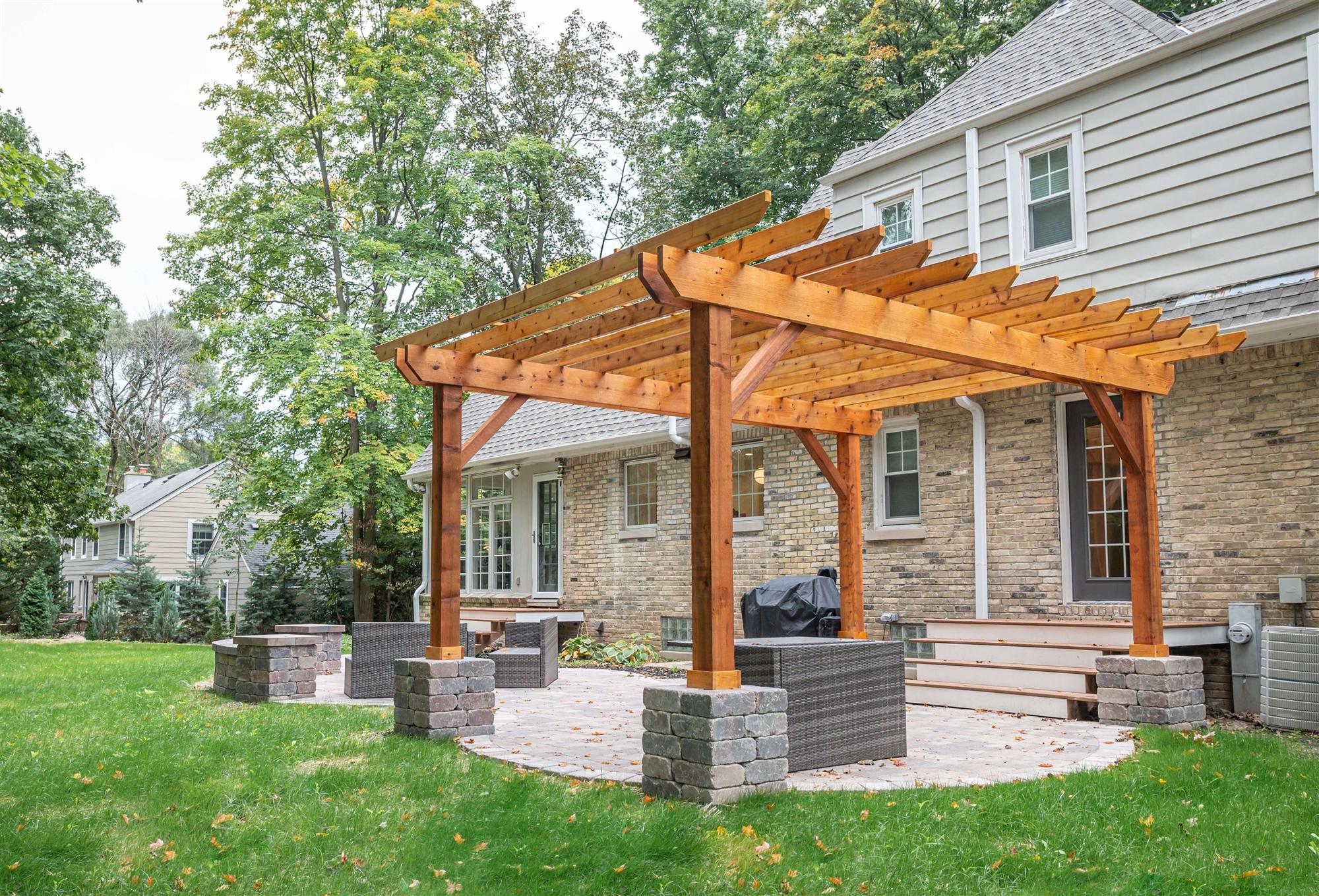 Stone paver patio with wooden pergola