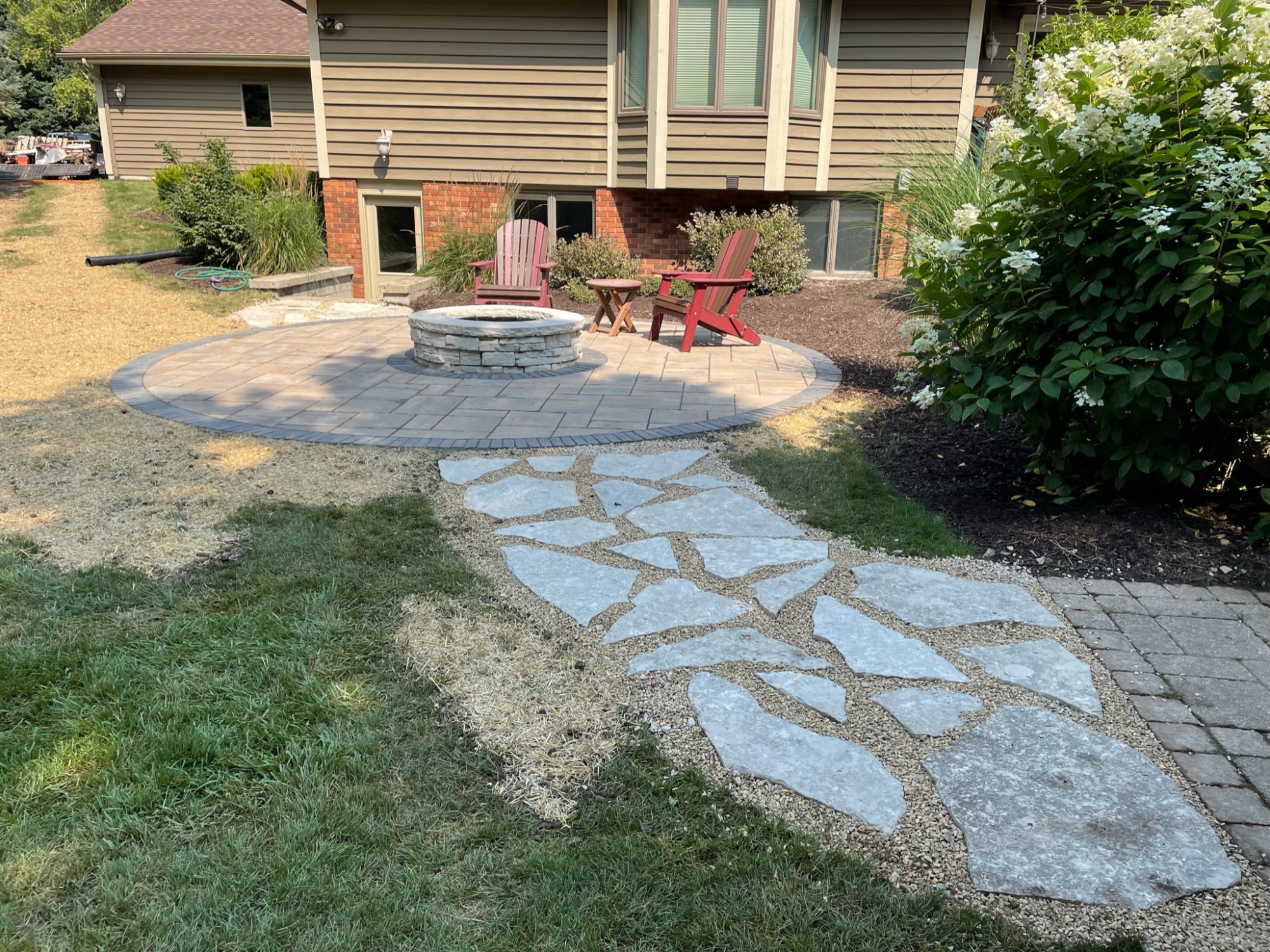 Stone walkway to patio with fire pit