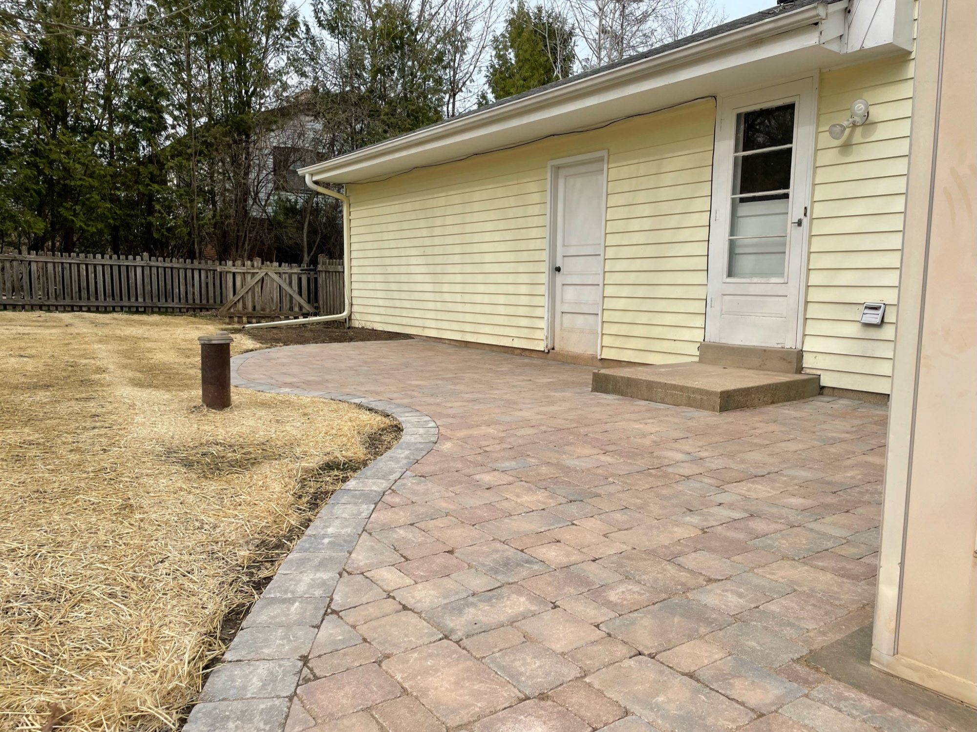 Outdoor stone patio with new grass